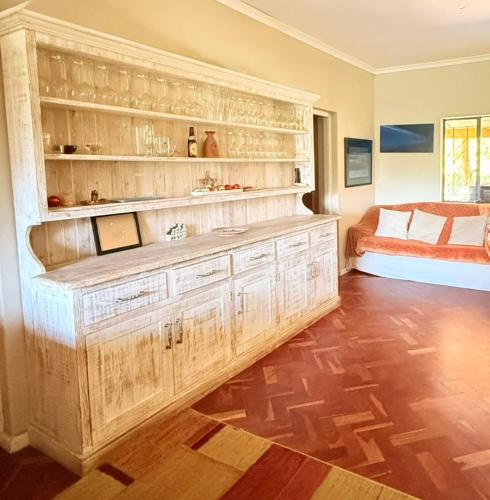 a bedroom with a large wooden cabinet and a bed at Franschhoek farm off the grid in Franschhoek
