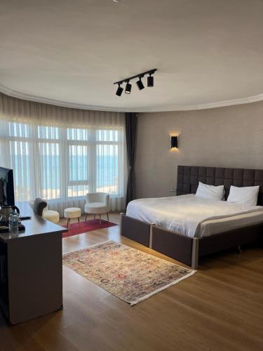 a bedroom with a large bed and a living room at NEW HOTEL SAMSUN in Samsun