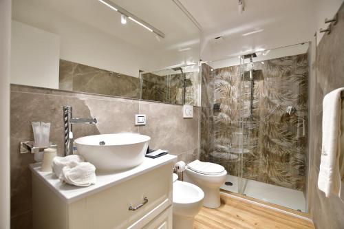 a bathroom with a sink and a toilet and a shower at Domus De Cinti Charme Rooms in Tivoli