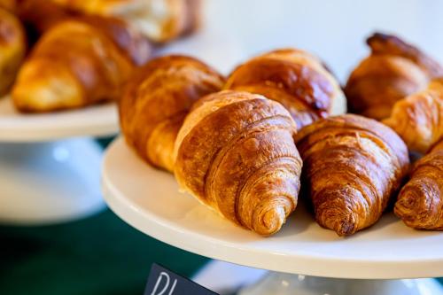a plate with croissants and other pastries on it at Hotel Laurin in Lido di Camaiore