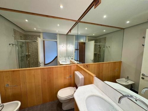 a bathroom with a toilet and a sink and a mirror at Appartamento Zipser II in Grado