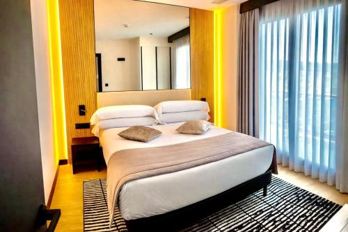 a hotel room with two beds and a window at AZ Appart hotels Saitour in Mazagran