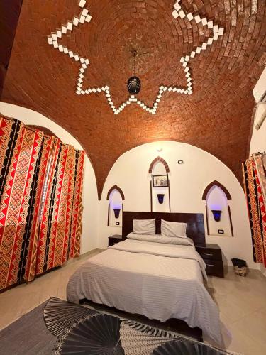 a bedroom with a bed and a brick wall at Oriental house in Luxor