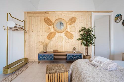 a bedroom with a bed and a mirror on a wall at Corina Secret Rooms in Martano