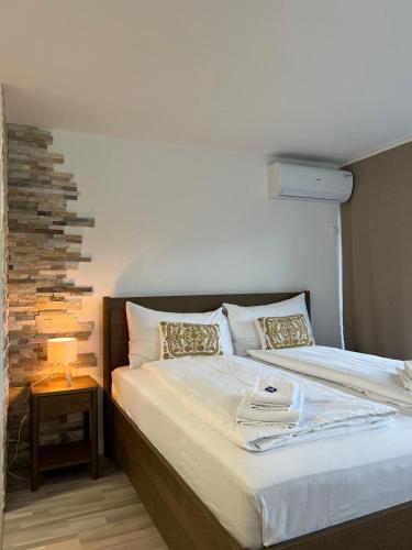 a bedroom with a bed with a lamp on a table at Rawda Ferien Wohnung in Interlaken
