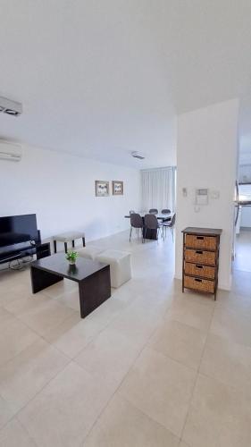 a living room with a couch and a table at Carilo - semipiso 3 ambientes 1ºpiso in Carilo