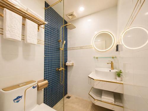 a bathroom with a toilet and a sink and a mirror at Arina Luxury Hotel - Vincom Tay Ninh in Tây Ninh