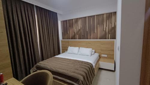 a hotel room with a bed and a window at Serge Otel in Arapkir
