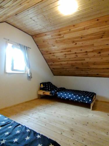 a room with a bunk bed in a attic at Agroturystyka Kozianka in Iława