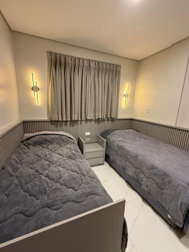 a bedroom with two beds and a window at Charming Apartment in the Central Square in Bonito