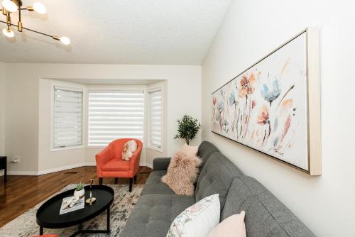 a living room with a couch and a table at Fabulous Home-King bed-Easy Access to EVERyTHING! in Edmonton
