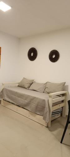a bedroom with a bed with two mirrors on the wall at Oasis Urbano Departamento Temporal in Santiago del Estero