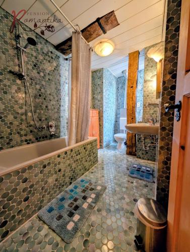 a bathroom with a shower and a tub and a sink at Gästehaus Pension Romantika in Cochem