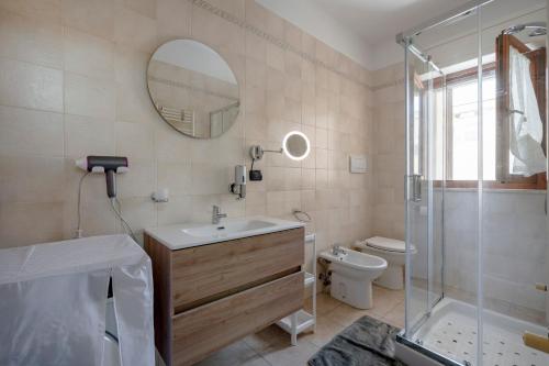 a bathroom with a sink and a shower and a toilet at Levante Eight Sea View Apartment in Bari