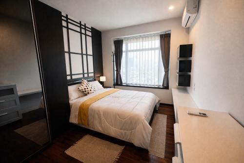 a small bedroom with a bed and a window at NexStay Bangkok Appartment in Bangkok