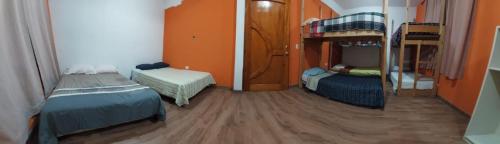 a room with two beds and two bunk beds at Hostal Las Armonías 3 in Panajachel