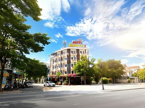 a building with a hotel sign on top of it at Mimosa 2 Hotel - Phan Rang in Phan Rang–Tháp Chàm