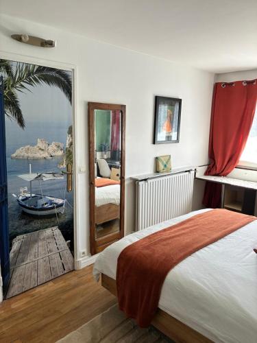 a bedroom with a bed and a view of the ocean at LA Petite ferme 1 in Saint-Maur-des-Fossés