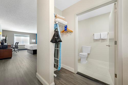 a room with a bathroom with a toilet and a bedroom at Comfort Inn & Suites Mt Laurel-Philadelphia in Mount Laurel