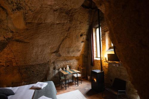 a bedroom with a table in a stone wall at La Voûte Etoilée in Doué-la-Fontaine