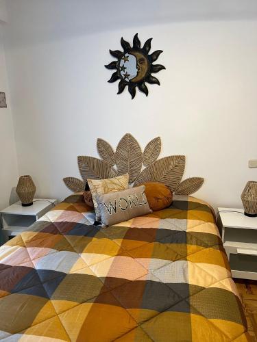 a bedroom with a bed with a clock on the wall at Camurichico in Figueira da Foz