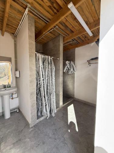 a bathroom with a sink and a wall with sculptures at KyzArt Hotel & Horse Tours in Bagysh