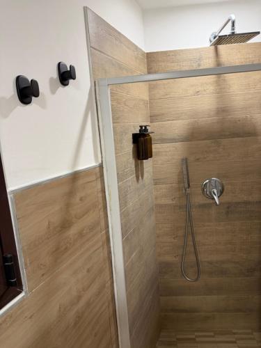 a shower with a glass door in a bathroom at Casetta Villabate in Villabate