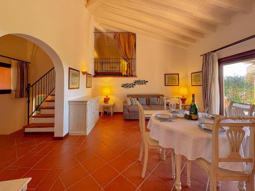 a living room with a table and a couch at Villa Gilda - Private Pool by Host Hero in Stintino