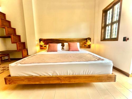 a bedroom with a bed with a wooden bed frame at Masaya Cartagena in Cartagena de Indias