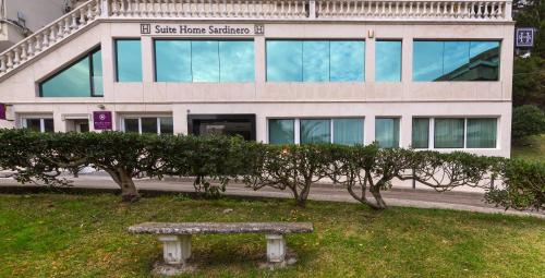 a stone bench in front of a building at Suite Home Sardinero in Santander