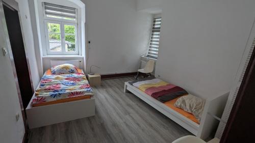 a small room with two beds and a window at Altstadthaus in Arnsberg