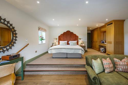 a bedroom with a large bed and a couch at Morston Hall in Holt