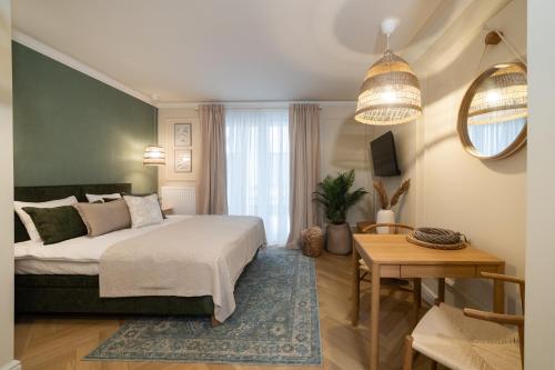 a bedroom with a bed and a table at Milla Apartamenty 102 in Zamość