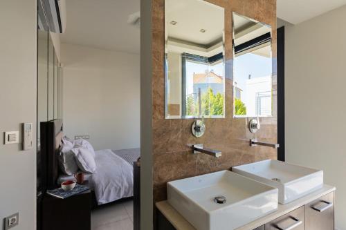a bathroom with a sink and a mirror at Ixia Pool Villa with sea view roof top in Ixia