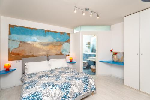 a bedroom with a bed and a painting on the wall at My Suite Sorrento in Sorrento