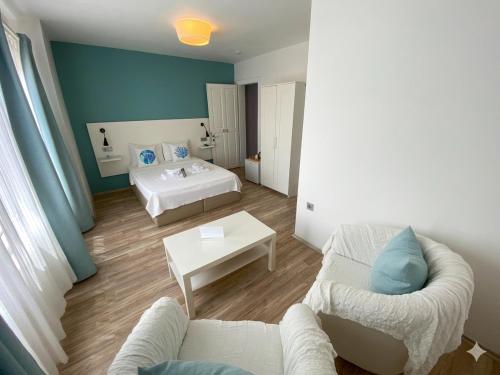 a living room with a couch and a bed at Alicante Otel - Adult Only in Bozcaada
