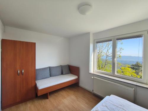a room with a bench and a window in it at Tau Forest Lodge in Solkan