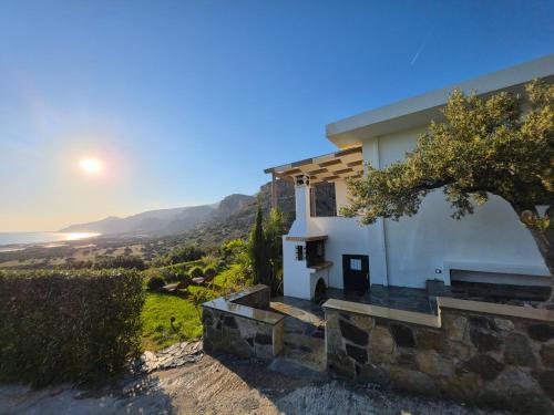 a white house with a view of the ocean at Casa di Olive Luxury Secluded Sea View Villa in South Crete in Goúdhouros