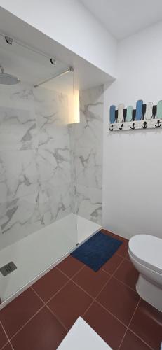 a bathroom with a shower and a toilet at Apartment with a stunning view over Sesimbra in Sesimbra