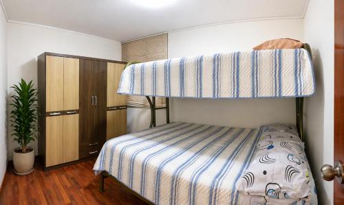 a bedroom with a bed with a bunk bed at Departamento Privado in Lima
