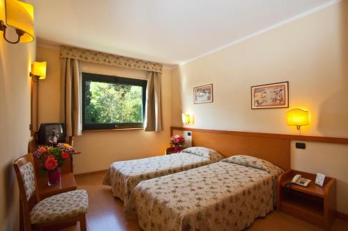 מיטה או מיטות בחדר ב-Sangallo Park Hotel