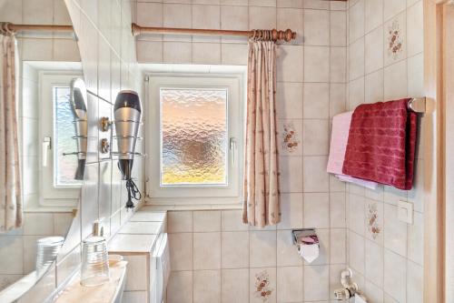 a bathroom with a sink and a window at Ferienwohnung 1 in Wallgau