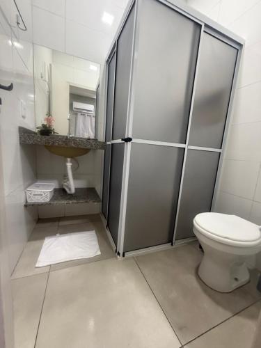 a bathroom with a toilet and a sink at Amazon loft 03 in Sorriso