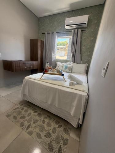 a bedroom with a bed and a window at Amazon loft 03 in Sorriso