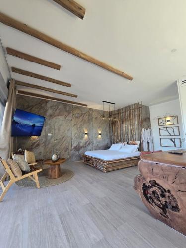 a bedroom with a king sized bed and a couch at מרום הגילבוע in Gid‘ona