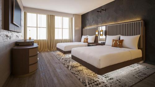 a hotel room with two beds and a television at The Berkeley Richmond, Outset Collection by Hilton in Richmond