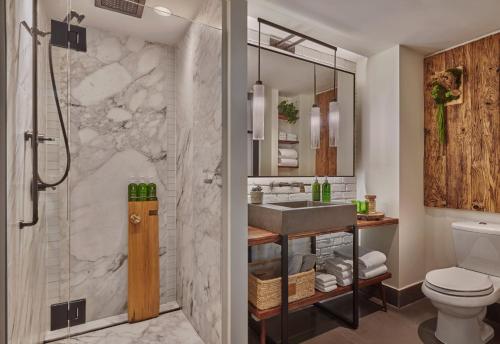 a bathroom with a shower and a sink at 1 Hotel Central Park in New York