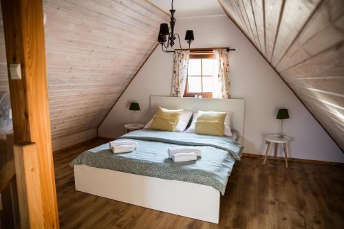 a bedroom with a bed in a attic at Leśne Siedlisko in Józefów