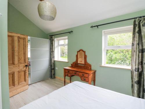 a bedroom with a bed and a table and a window at The Stable in Dublin