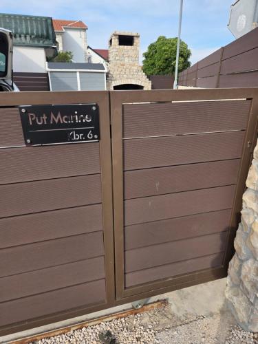 a wooden gate with a sign on it at Apartment Vi & La ELECTRIC SCOOTERS included in Vir